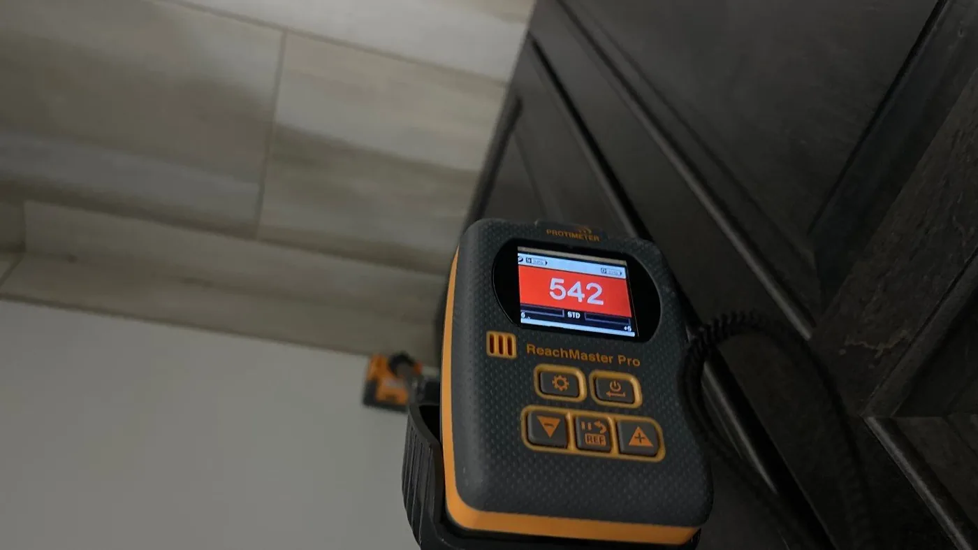 Protimeter moisture meter reading elevated moisture during a Jupiter, FL mold inspection