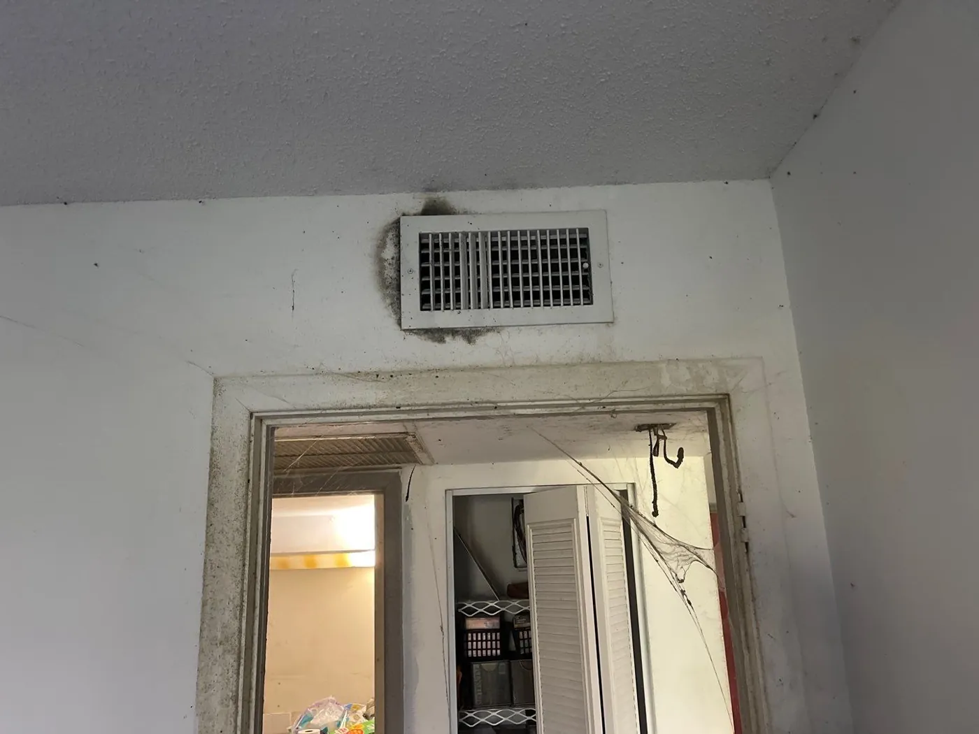 Mold staining around a ceiling supply vent during a Lake Worth Beach, FL mold inspection
